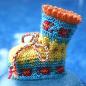 Knit booties with fish motif knit in Dale of Norway Baby Ull merino wool yarn