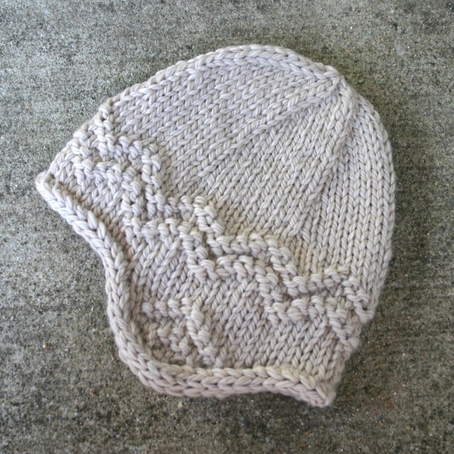 Free knitting pattern for an adult's earflap hat, knit in bulky weight wool.
